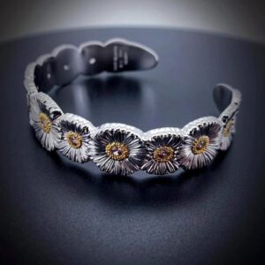 Floral - Themed Cuff Bracelet with Textured Metal and Contrasting Accents